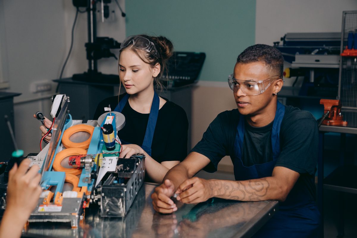 Technicians reviewing equipment in a manufacturing environment